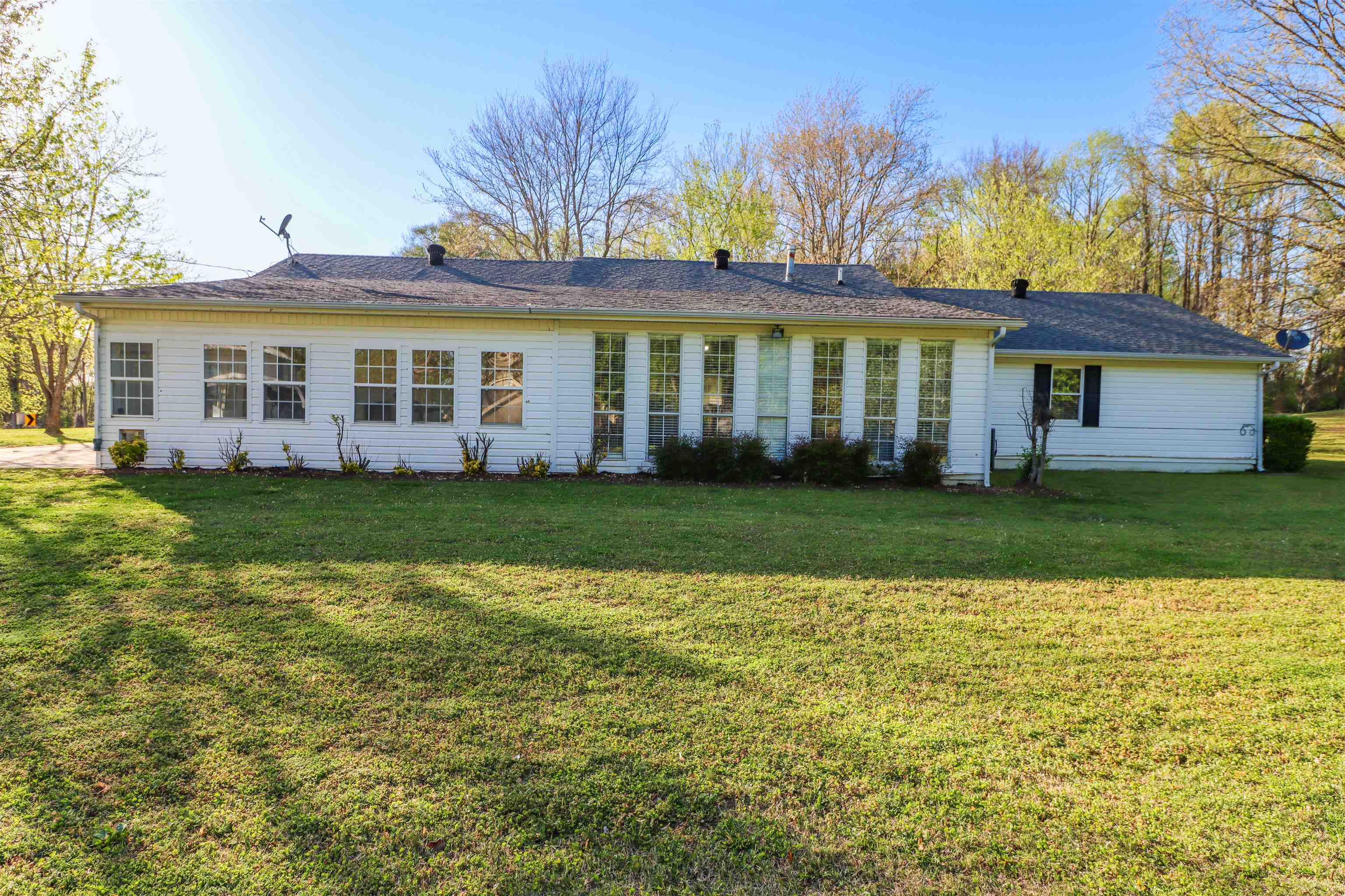 5551 Asbury Glimp Road Ripley, TN 38063 - Photo 6 of 28 a view of a house with a garden and trees