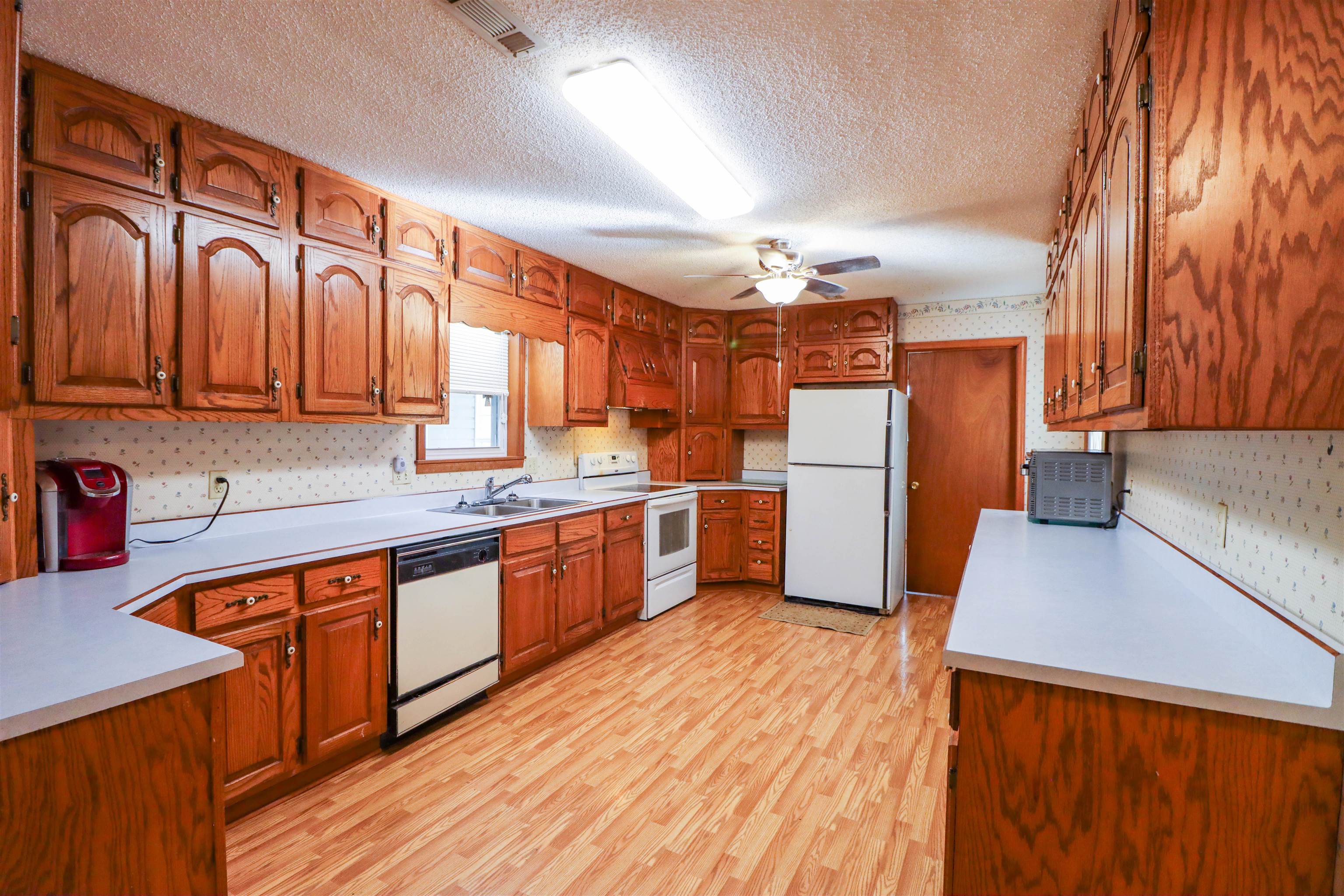 5551 Asbury Glimp Road Ripley, TN 38063 - Photo 10 of 28 a large kitchen with stainless steel appliances wooden floors and wooden cabinets