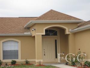 2817 13th Street Southwest Lehigh Acres, FL 33976 - Photo 2 of 9 a front view of a house