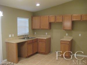2817 13th Street Southwest Lehigh Acres, FL 33976 - Photo 6 of 9 a kitchen with a sink and cabinets