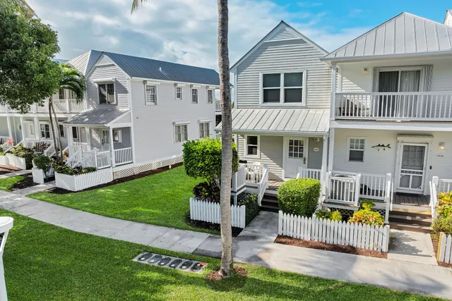 a front view of a house with a yard and porch