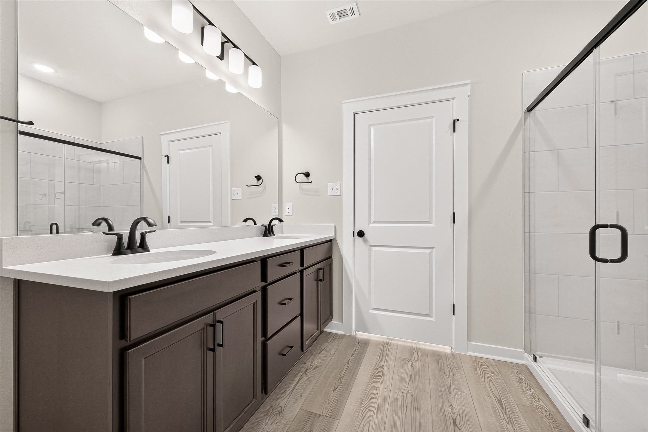 21122 Autumn Heights Rosharon, TX 77583 - Photo 28 of 42 a bathroom with a double vanity sink a mirror and a shower