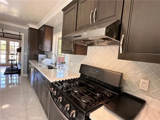 a kitchen with a stove and a sink