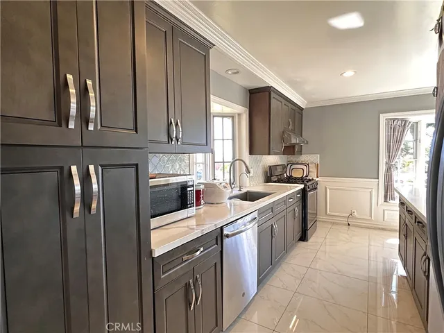 a kitchen with a sink refrigerator and cabinets
