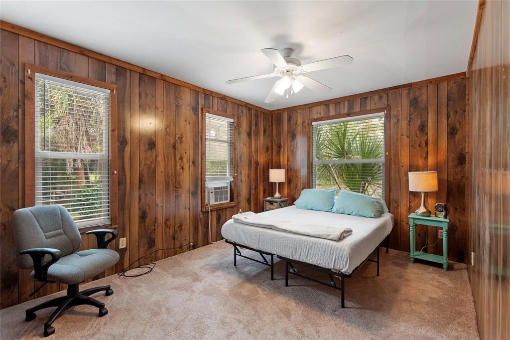 3641 Turtle Mound Road Melbourne, FL 32934 - Photo 38 of 77 a bedroom with a bed and a chandelier