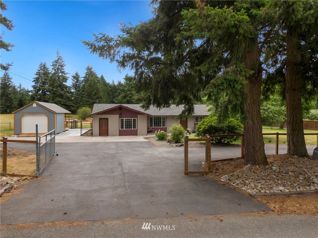 19206 Loganberry Street Southwest Rochester, WA 98579 - Photo 1 of 39 a view of a house with a yard and large tree