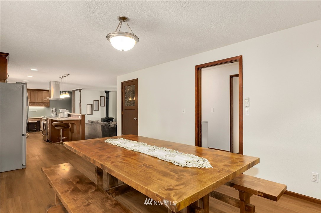 19206 Loganberry Street Southwest Rochester, WA 98579 - Photo 12 of 39 a living room with stainless steel appliances kitchen island furniture and wooden floor