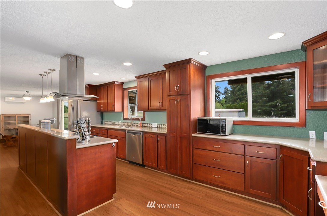 19206 Loganberry Street Southwest Rochester, WA 98579 - Photo 14 of 39 a kitchen with stainless steel appliances granite countertop a sink dishwasher stove and refrigerator