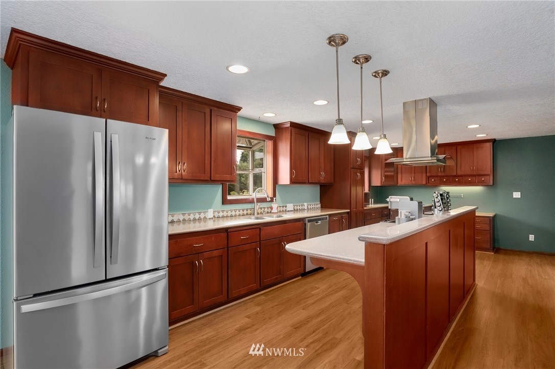 19206 Loganberry Street Southwest Rochester, WA 98579 - Photo 15 of 39 a kitchen with stainless steel appliances a refrigerator and a wooden cabinets