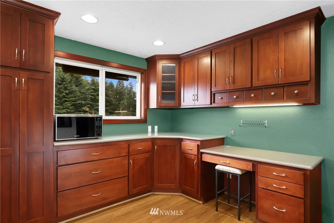 19206 Loganberry Street Southwest Rochester, WA 98579 - Photo 17 of 39 a kitchen with a sink and wooden cabinets