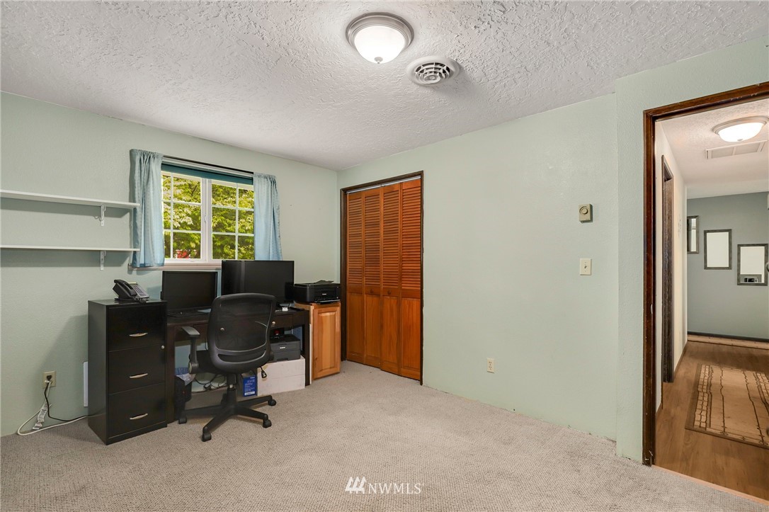19206 Loganberry Street Southwest Rochester, WA 98579 - Photo 24 of 39 a view of a workspace with furniture and a window