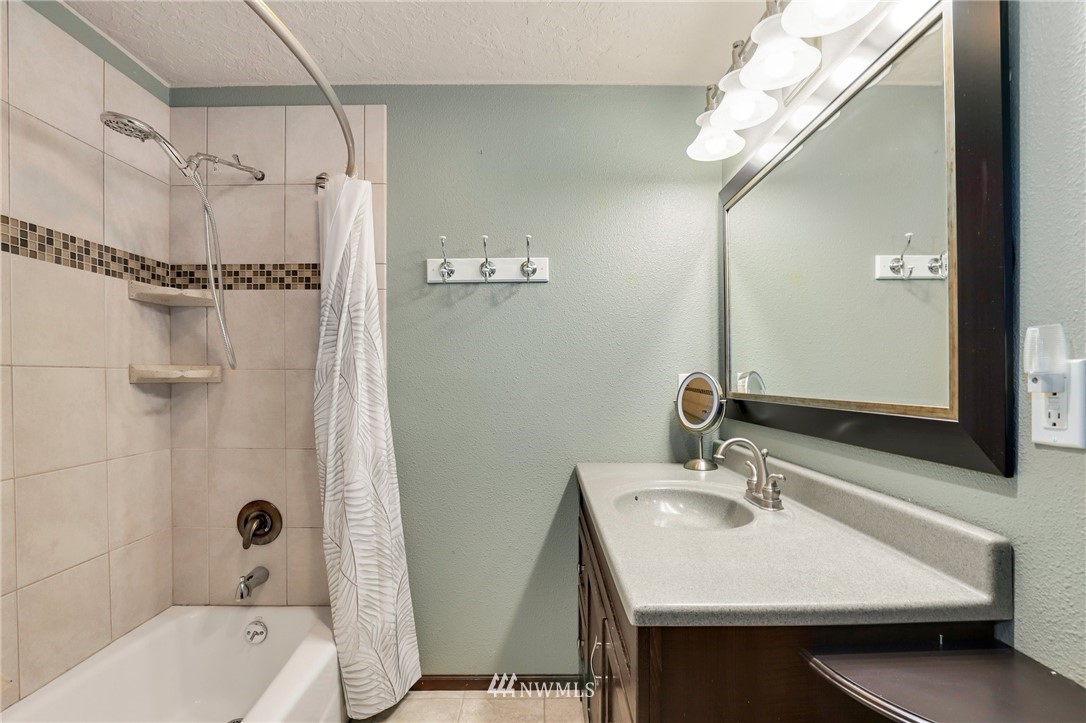 19206 Loganberry Street Southwest Rochester, WA 98579 - Photo 26 of 39 a bathroom with a sink a toilet a mirror and shower