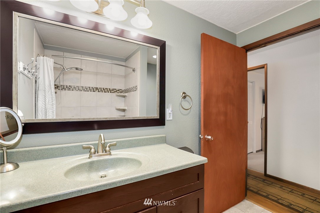 19206 Loganberry Street Southwest Rochester, WA 98579 - Photo 27 of 39 a bathroom with a sink and a mirror
