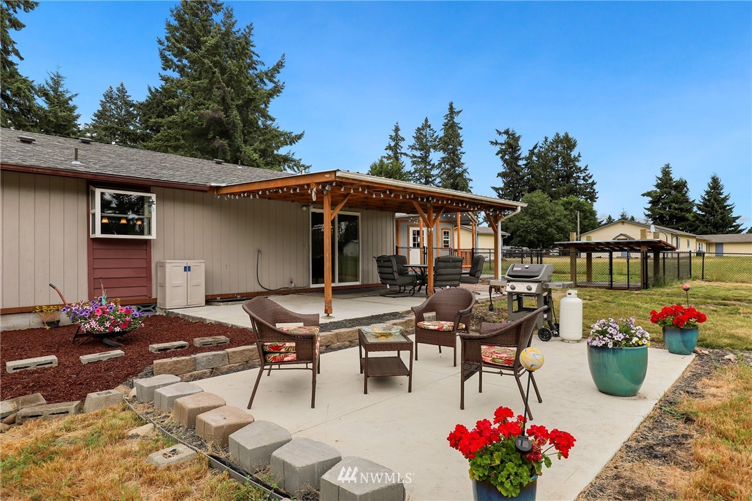 19206 Loganberry Street Southwest Rochester, WA 98579 - Photo 31 of 39 a view of a patio with table and chairs potted plants