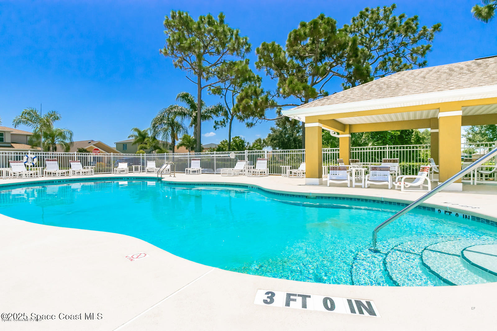 3180 Constellation Drive Melbourne, FL 32940 - Photo 18 of 18 a view of a swimming pool with a lawn chairs and potted plants