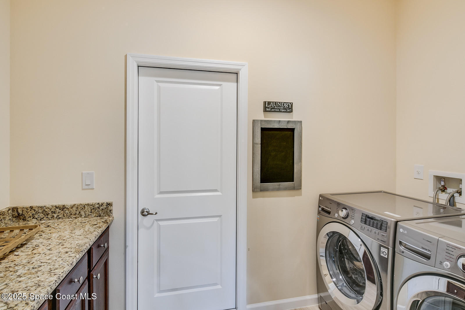 3180 Constellation Drive Melbourne, FL 32940 - Photo 8 of 18 a utility room with dryer and washer