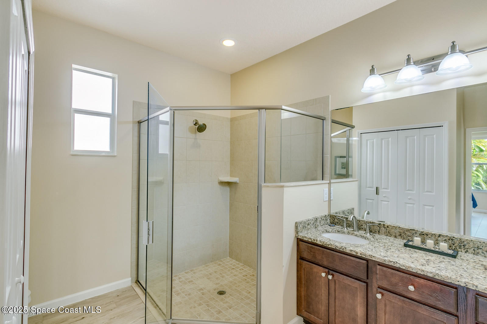 3180 Constellation Drive Melbourne, FL 32940 - Photo 10 of 18 a bathroom with a granite countertop shower sink and mirror