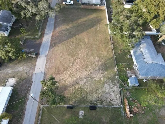 an aerial view of a house with a yard
