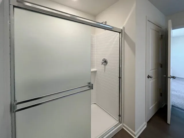 a bathroom with a glass shower door