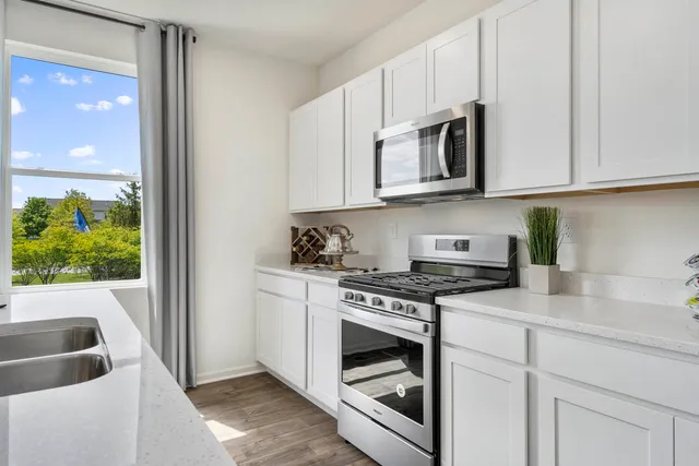 a kitchen with stainless steel appliances granite countertop a stove and a sink