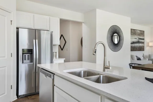 a kitchen with a refrigerator and a sink