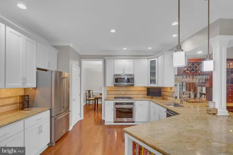 a kitchen with granite countertop cabinets stainless steel appliances and a sink