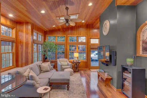 a view of a hallway with entryway wooden floor and a dining table