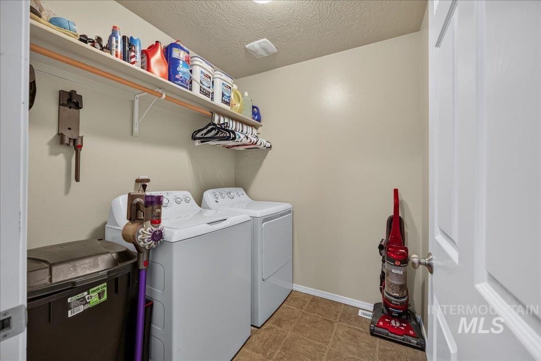 5106 Lathrop Place, Unit 19517 Caldwell, ID 83607 - Photo 25 of 29 Laundry area with a textured ceiling and washer and dryer
