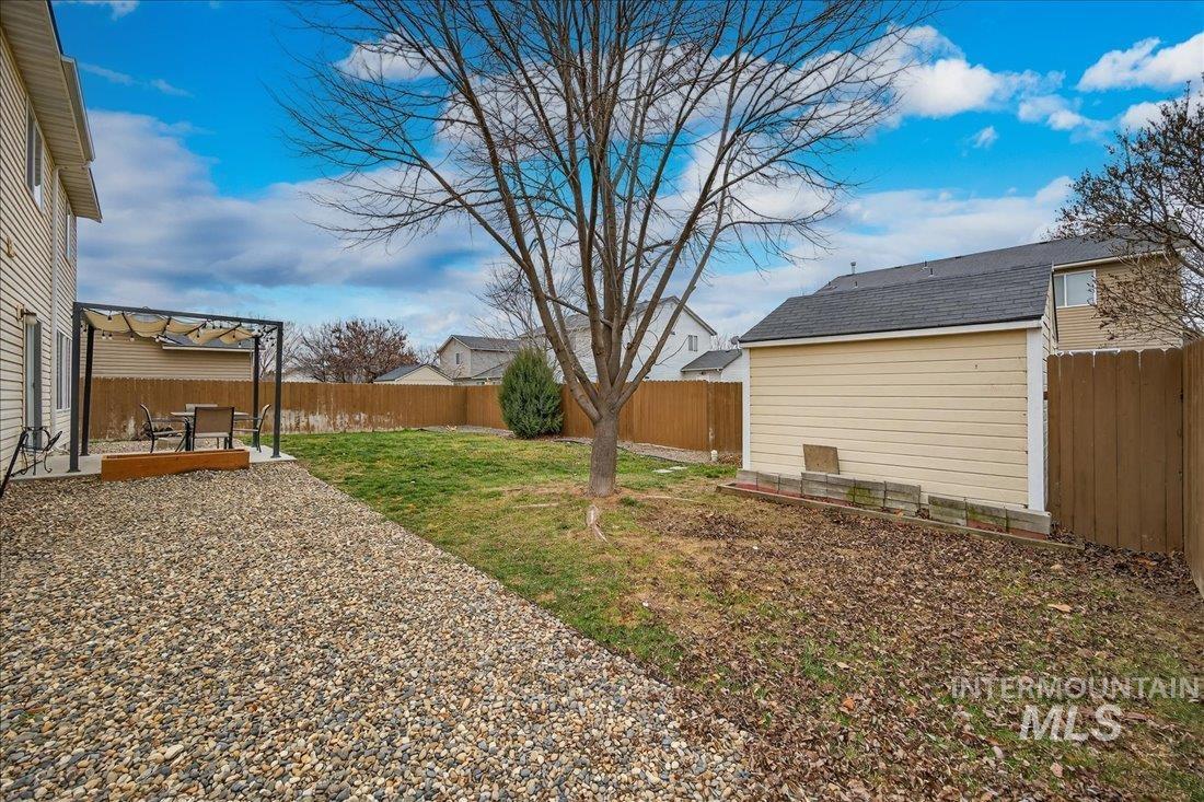 5106 Lathrop Place, Unit 19517 Caldwell, ID 83607 - Photo 6 of 29 Fenced backyard featuring a patio