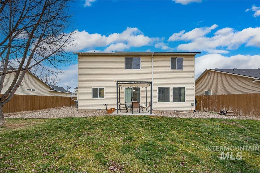 5106 Lathrop Place, Unit 19517 Caldwell, ID 83607 - Photo 9 of 29 Back of property featuring a patio and a fenced backyard