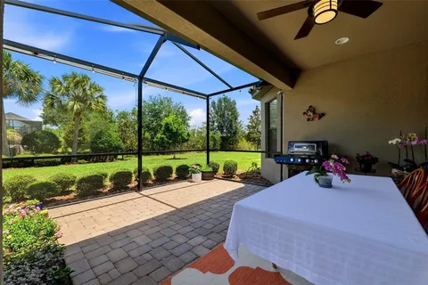 a view of a patio with a table chairs and a backyard