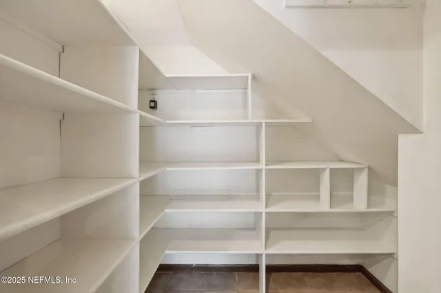 a view of a livingroom with a ceiling fan and window