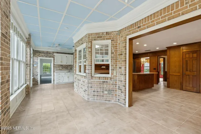 an empty room with closet and a ceiling fan