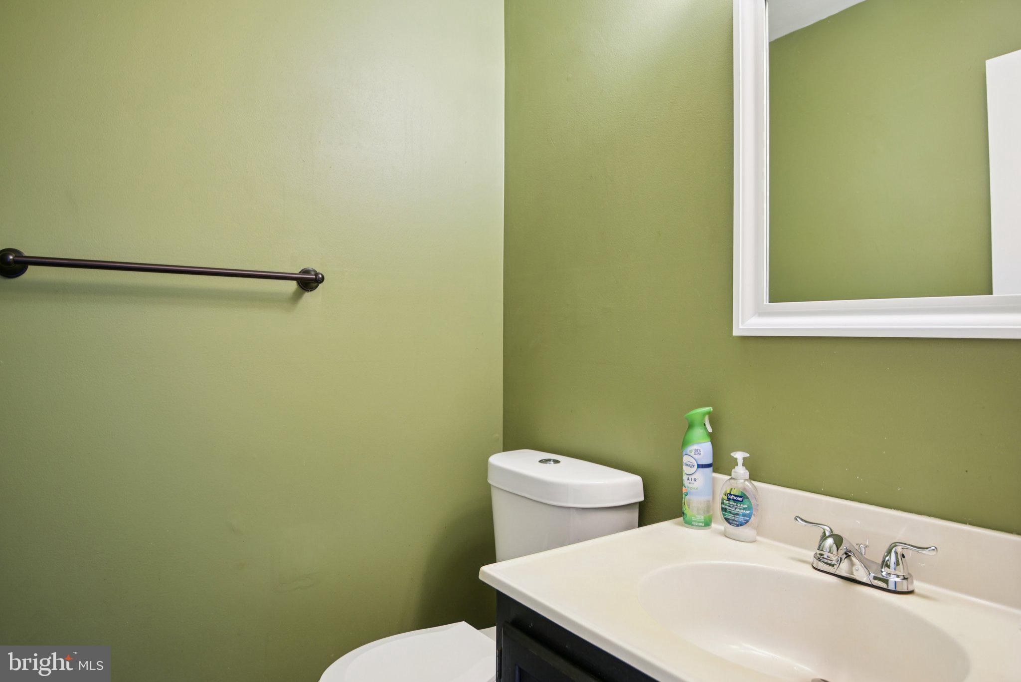 14921 Ladymeade Circle Silver Spring, MD 20906 - Photo 9 of 26 a white toilet sitting next to a bathroom sink