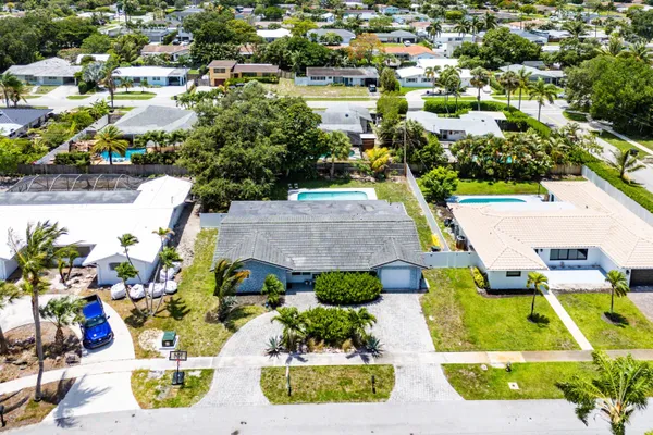 an aerial view of residential houses with swimming pool and outdoor space