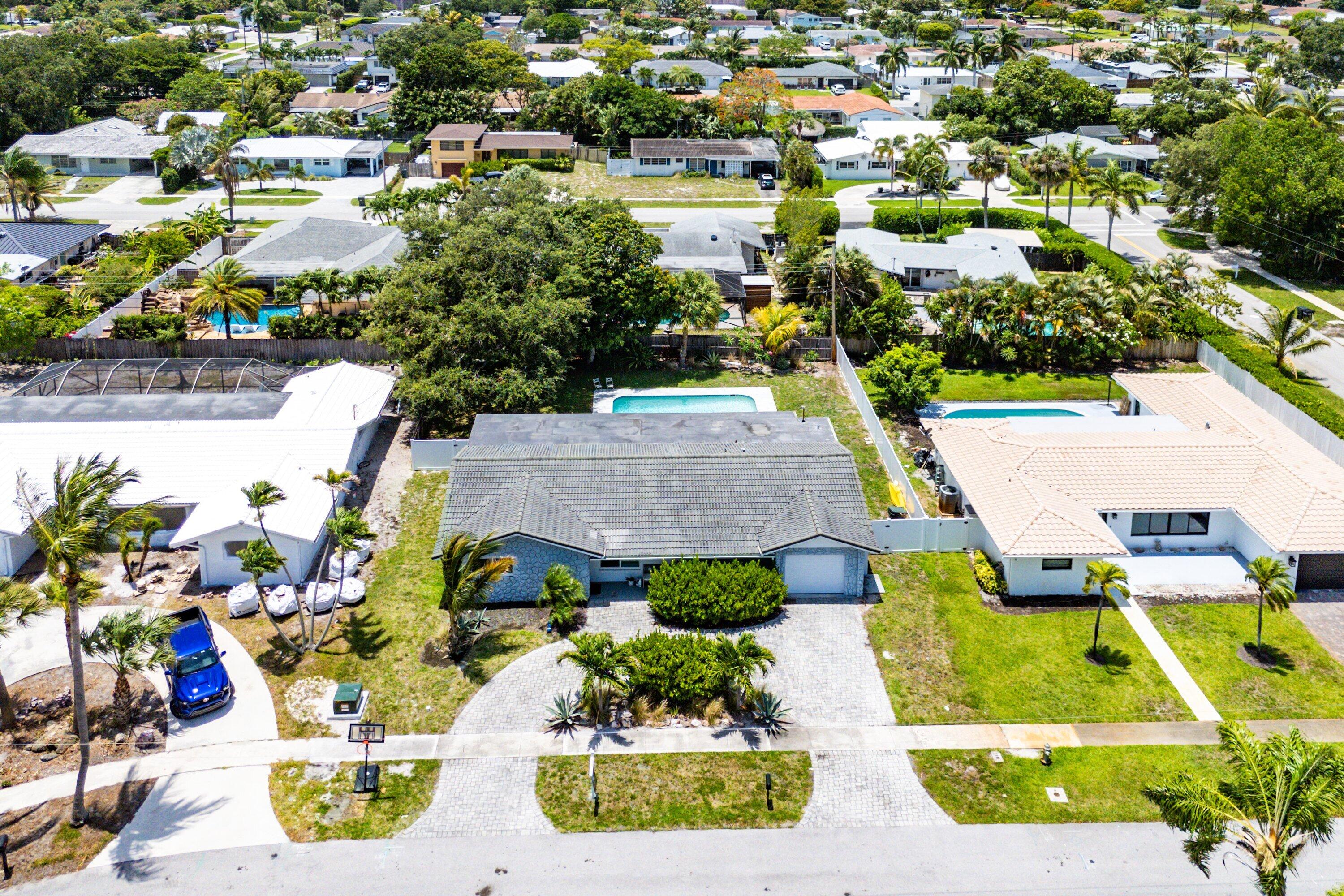 an aerial view of residential houses with swimming pool and outdoor space