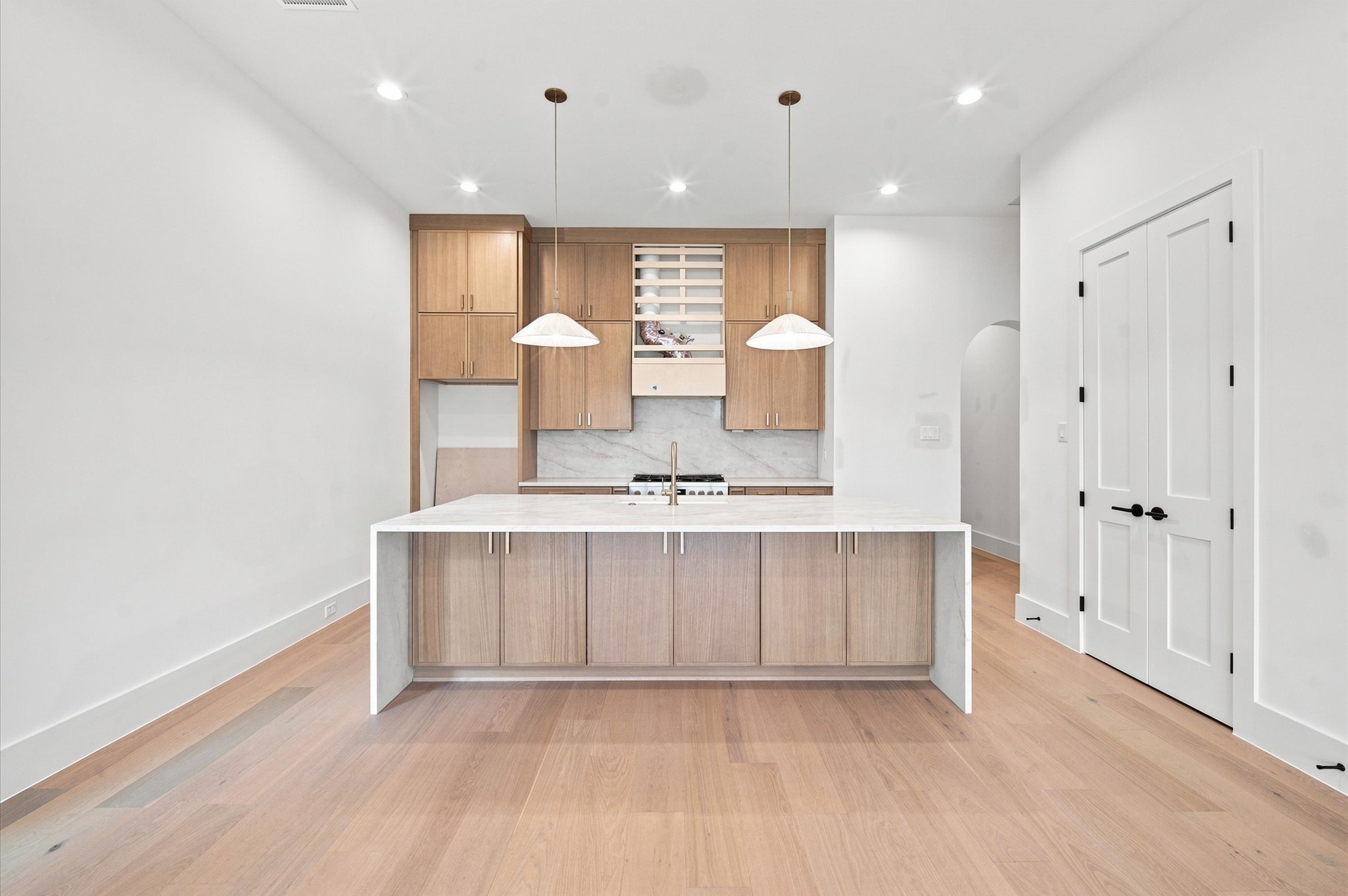 112 East 27th Street Houston, TX 77008 - Photo 6 of 43 Chef-inspired kitchen featuring white oak cabinetry, a quartz waterfall island and abundant storage.