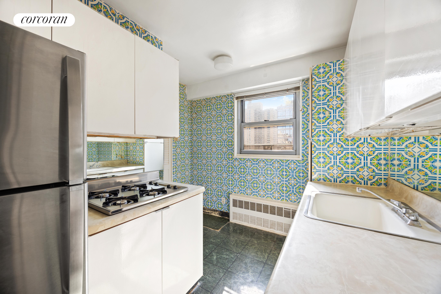 360 East 72nd Street, Unit C2003 Manhattan, NY 10021 - Photo 12 of 22 a kitchen with stainless steel appliances granite countertop a sink stove and refrigerator