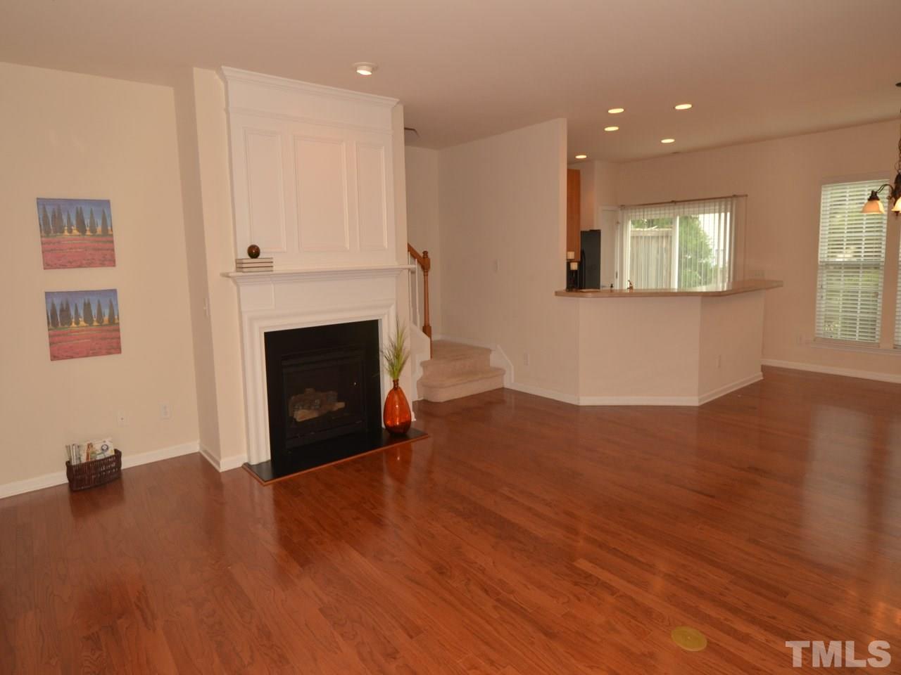 8709 Owl Roost Place Raleigh, NC 27617 - Photo 2 of 25 Upgraded oak hardwood flooring extends from the foyer through the family & dining. Beautifully constructed Heat & Glo gas log fireplace with over-mantel, fireplace surround and flush slate hearth. Cable port in the niche to the left of the fireplace.
