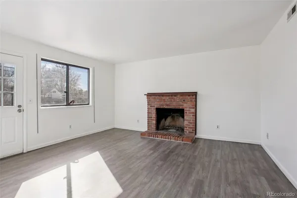 a view of empty room with window and fireplace