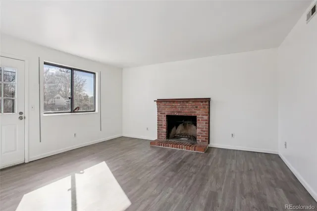 a view of empty room with window and fireplace