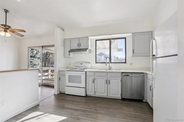 a kitchen with white cabinets and white appliances