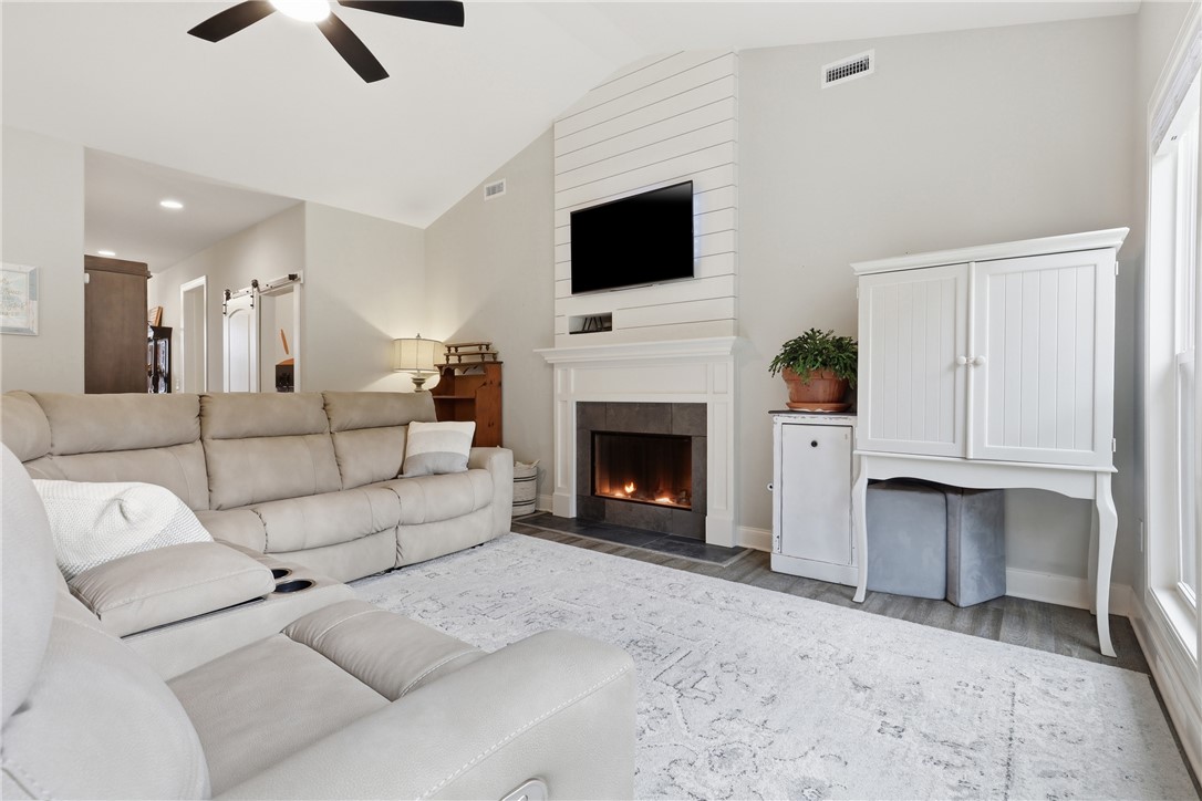 127 West Stewart Street Pelzer, SC 29669 - Photo 3 of 23 This inviting living space features vaulted ceilings and a warm fireplace.