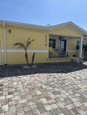 a view of a house with backyard and chair