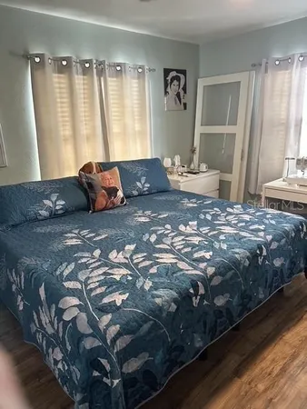 a large bed sitting in a bedroom next to a window