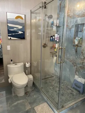 a bathroom with a toilet and a shower