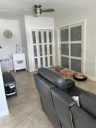 a living room with a bed furniture and a window