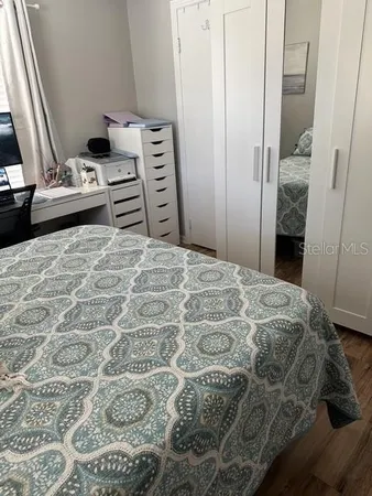 a bedroom with a bed and walk in closet