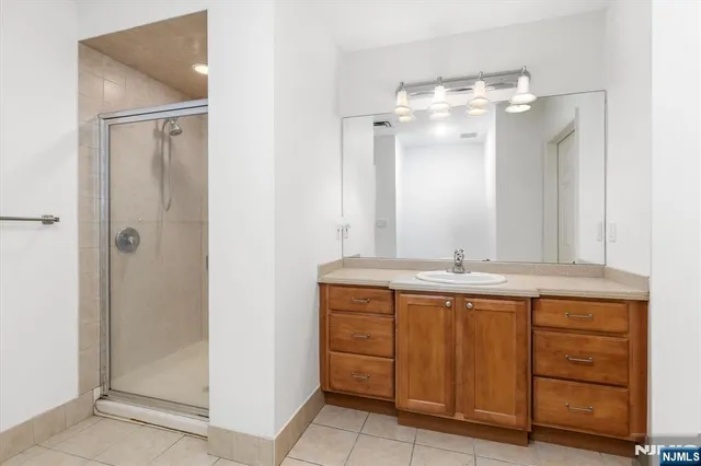 a bathroom with a shower and a sink