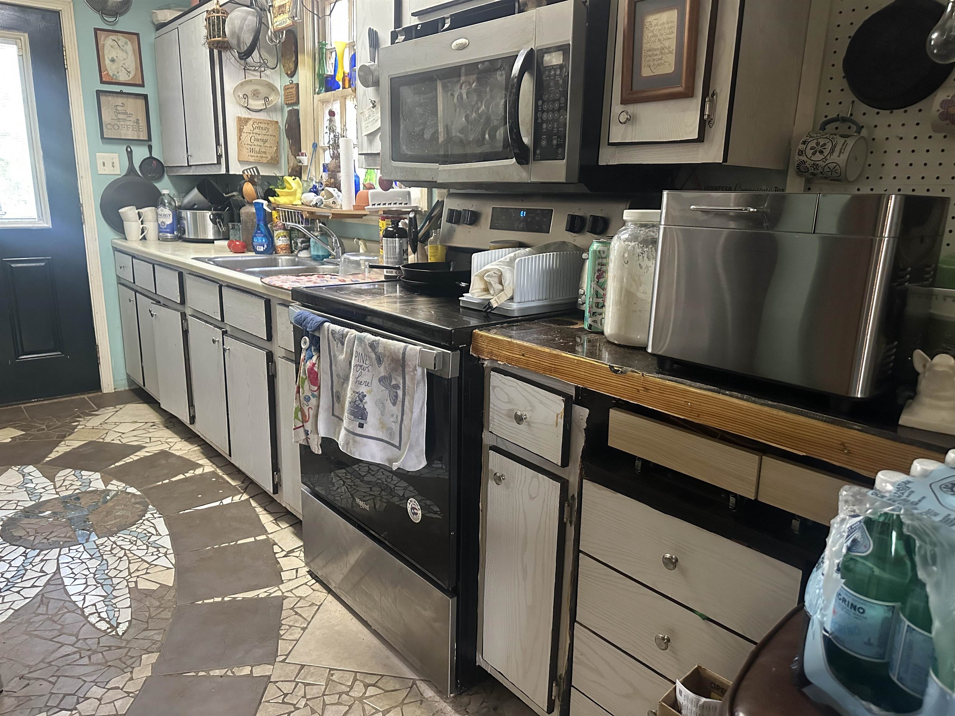 5865 Enville Road Henderson, TN 38340 - Photo 20 of 24 a kitchen with stainless steel appliances granite countertop a stove a sink and a microwave